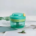 Green manual kitchen food grinder with transparent container and stainless steel blade for making baby food purees.