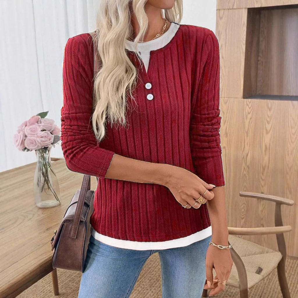 Women's black fake two-piece round neck pullover sweater with long sleeves.