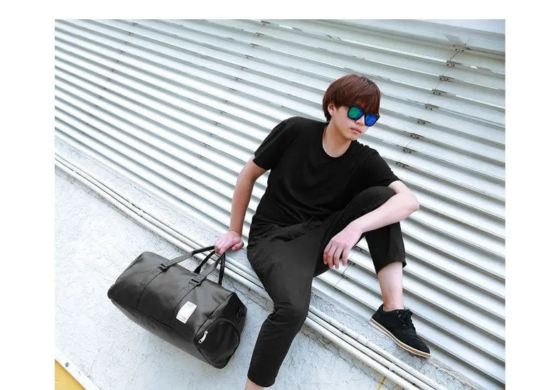 Black waterproof sports fitness bag with separate shoe compartments and diagonal carry straps.