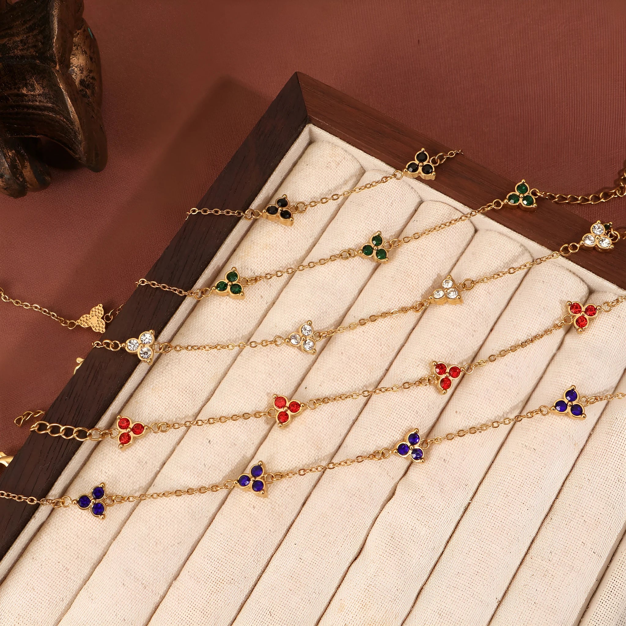 Women's stainless steel geometric bracelet with triangle elements and coloured stone settings