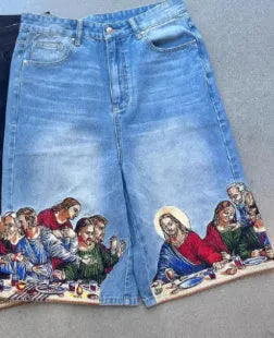 Blue cotton men's shorts with a Jesus Christ screen print on the back pocket, showing tapered leg fit.