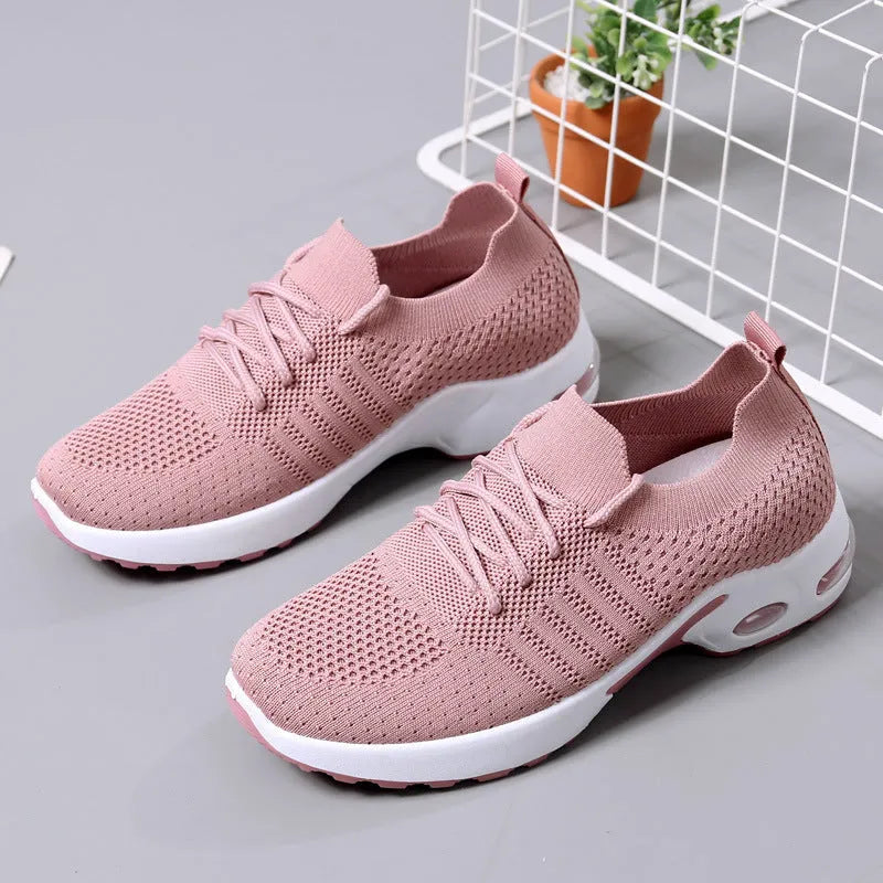 Women's black mesh sneaker with lace-up front and round toe on a non-slip PVC sole.