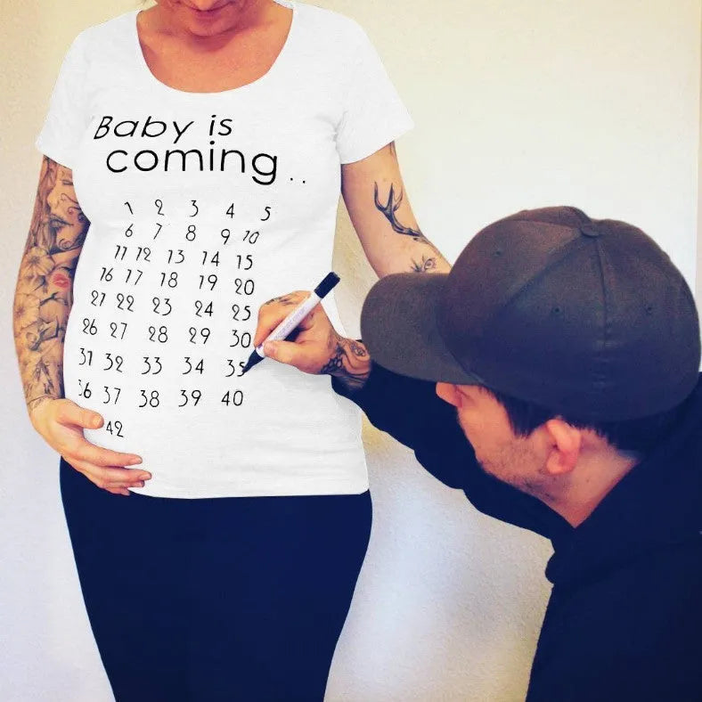 White cotton maternity t-shirt with hand print pattern, round collar, short sleeves on model