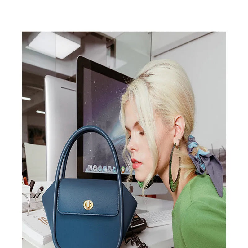 Women's wing-shaped leather tote bag with latch closure and cross-body strap in four colour options