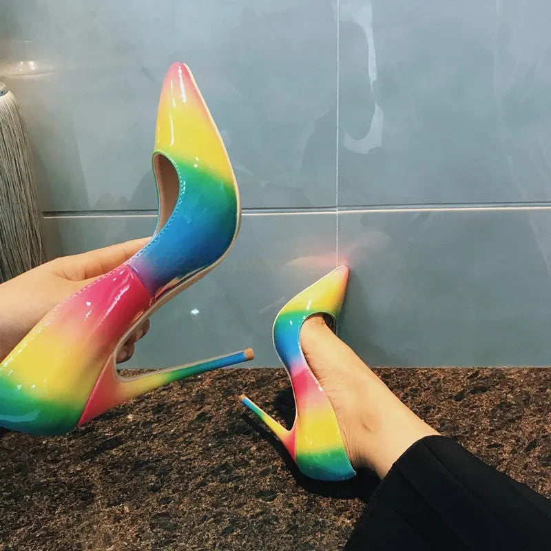 Rainbow glossy patent leather women's stiletto heels with a pointed toe and thin high heel.