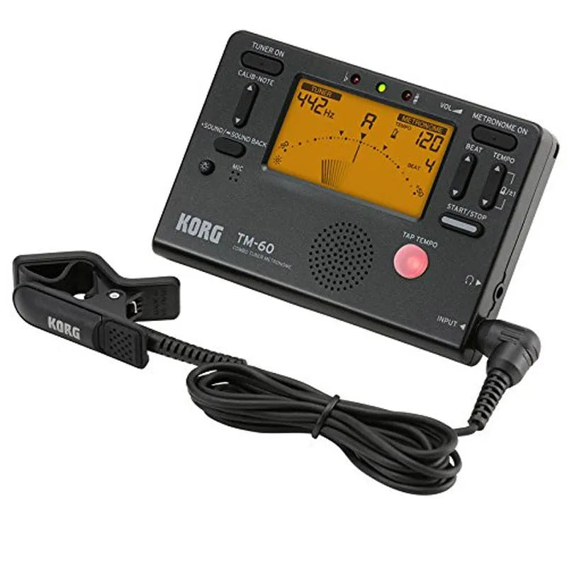 TM-60 black and white universal electronic metronome and tuner on a table.