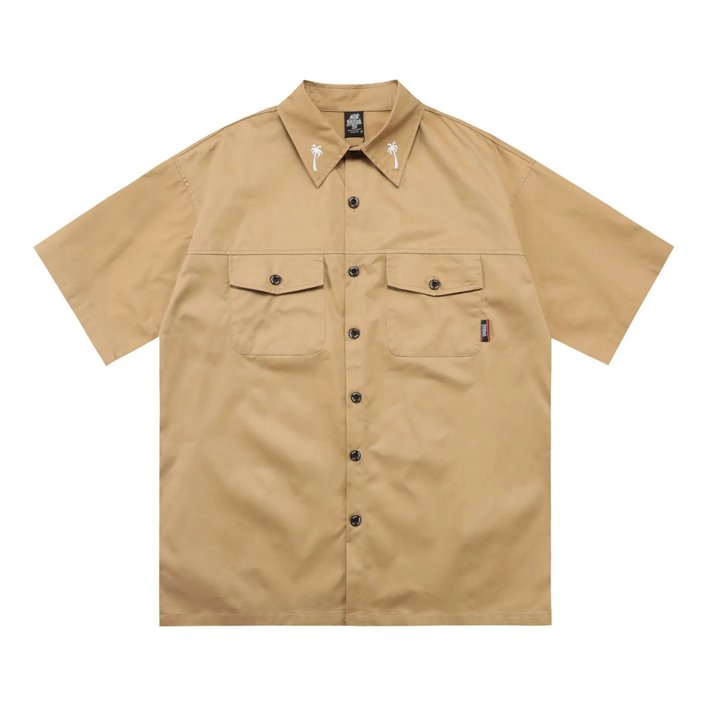 Men's black plus-size loose fit work shirt with a chest pocket and embroidered detail on the sleeve.