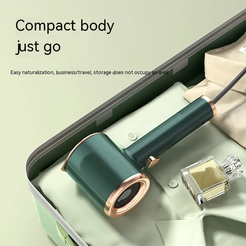 Mini handheld garment steamer in green with visual water tank and US plug
