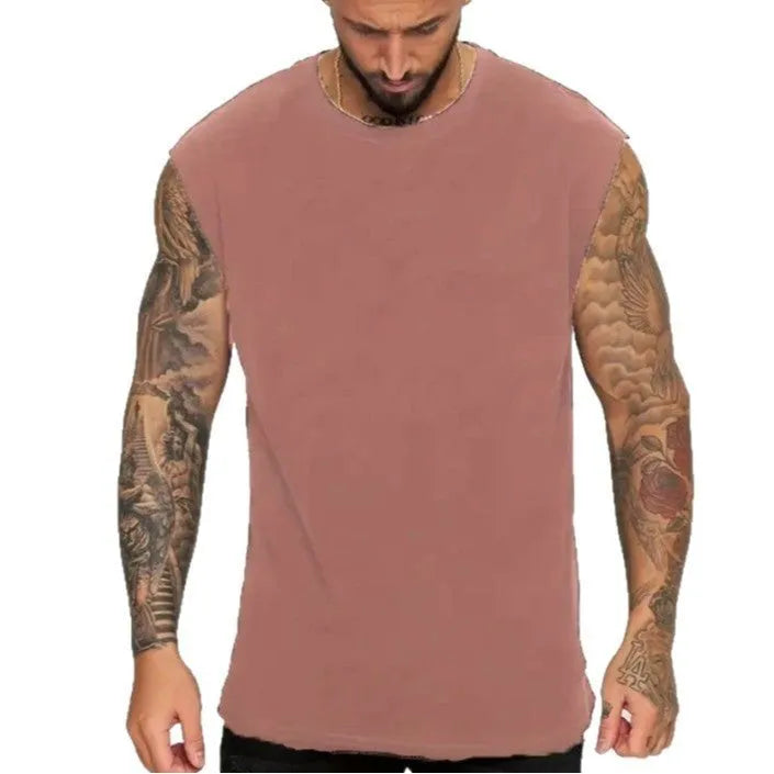Men's loose solid colour sleeveless cotton tank top on a hanger, shown in a light apricot shade.