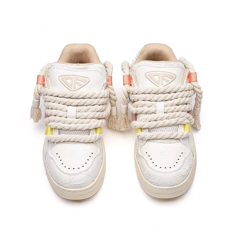 Creamy white retro low-top skate shoes with lace-up front and decorative stitching on a rubber sole.
