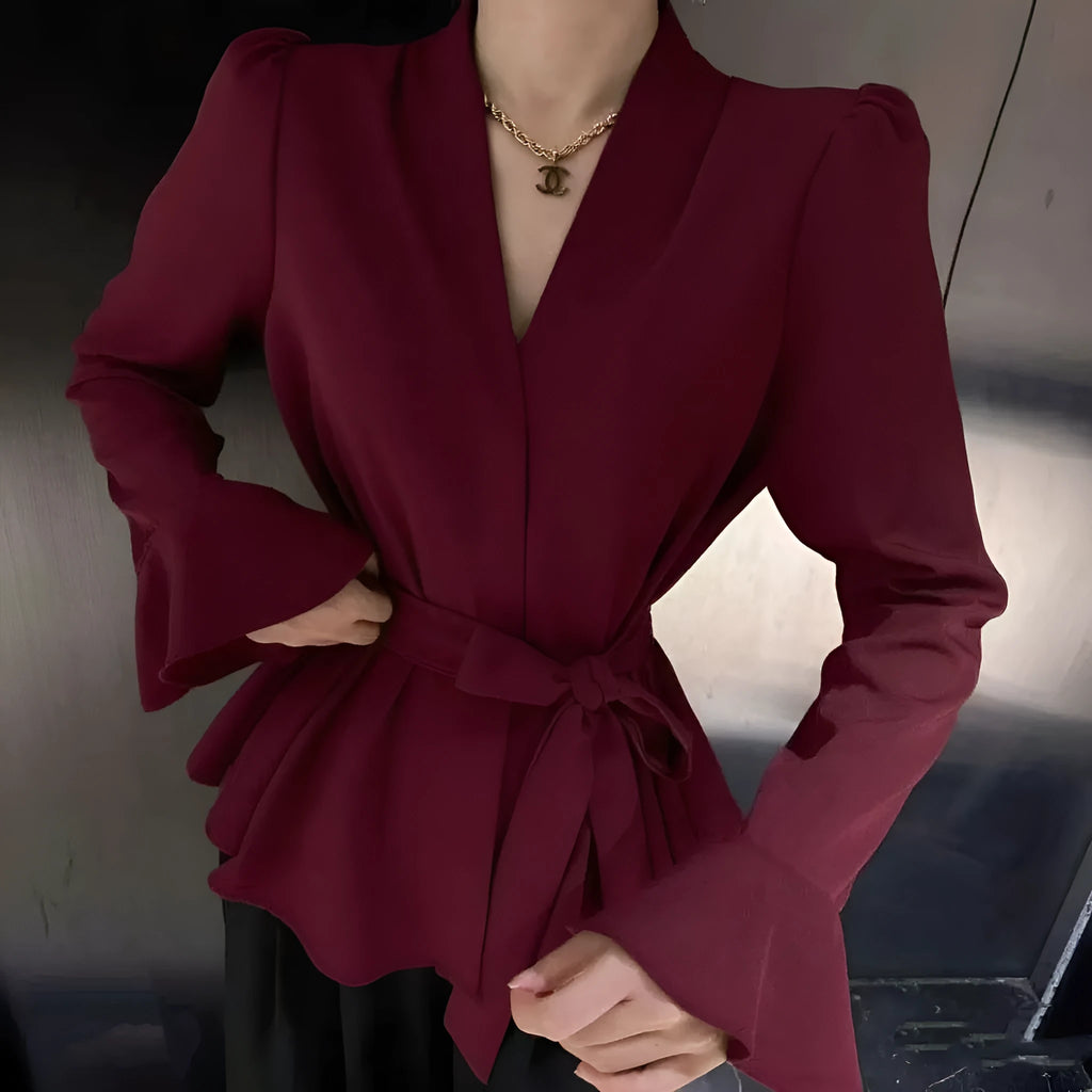 Women's black French-style shirt with irregular collar, long bell sleeves, and a front tie detail.