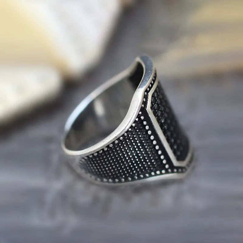 Black alloy ring with copper inlay and zircon stones, shown in a unisex European American design style.