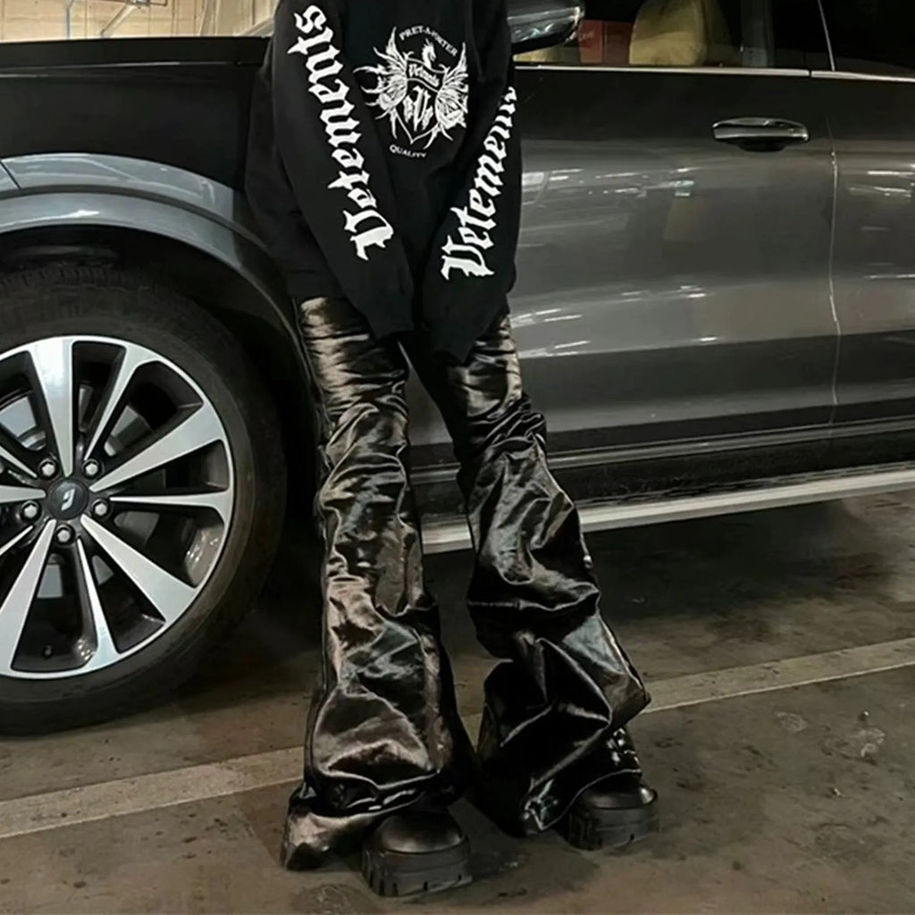 Black coated patent leather skinny jeans with a shiny straight-leg fit on a mid waist.