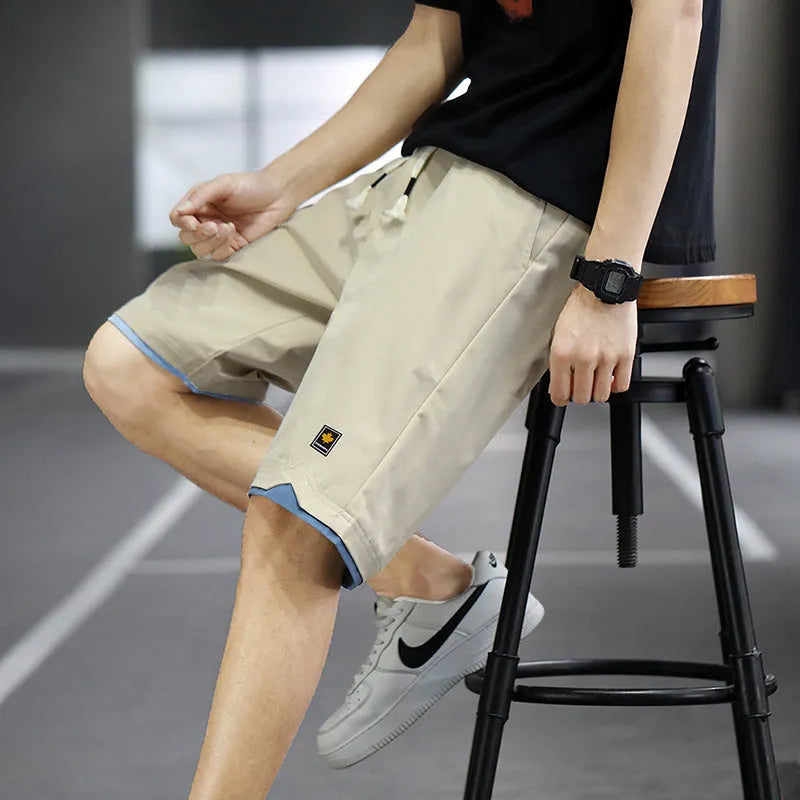 Men's loose-fit straight-leg casual beach shorts in polyester, shown in green.