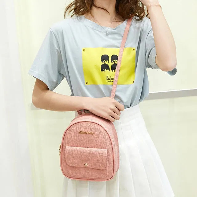 Women's small black PU leather backpack letter purse with shoulder strap measuring 18.5cm long