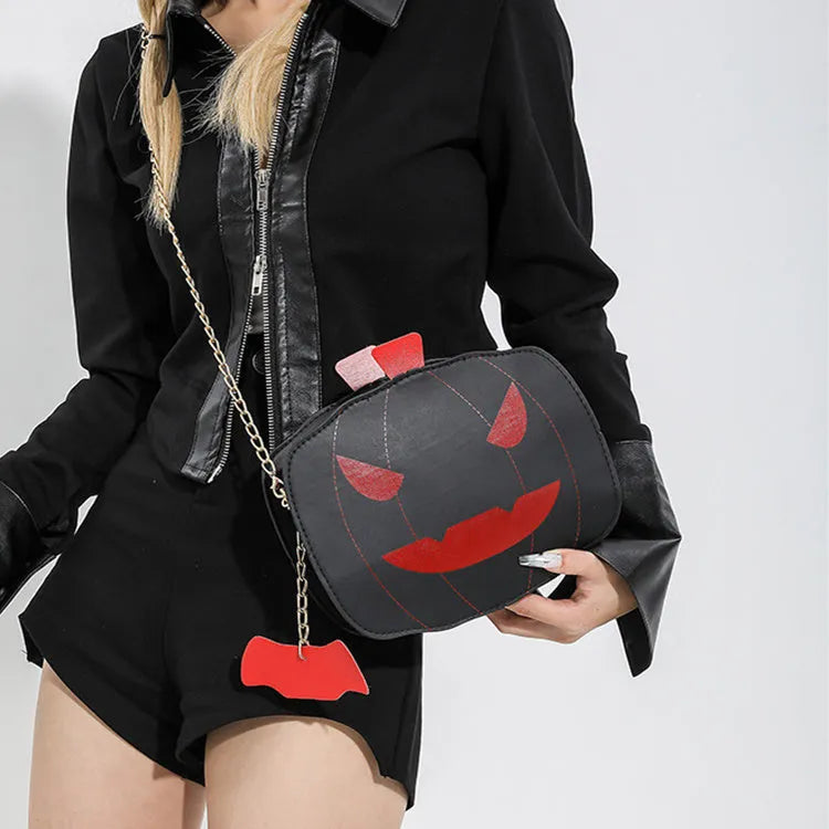 Cartoon pumpkin shoulder bag in orange with chain strap on white background