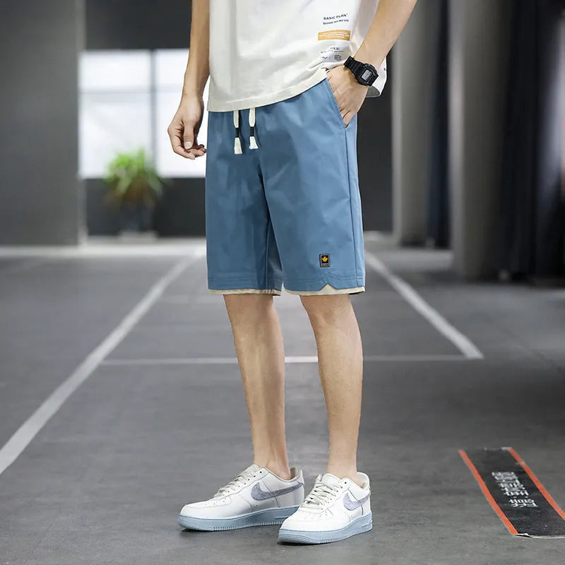 Men's loose-fit straight-leg casual beach shorts in polyester, shown in green.