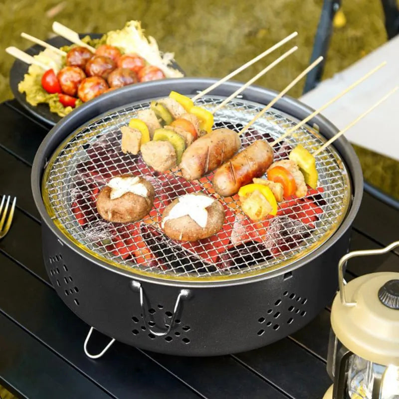 Portable stainless steel BBQ grill with detachable parts and storage bag, shown in grey colour.