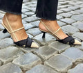 Apricot black women's pointed toe stiletto sandals with a buckle fastening.