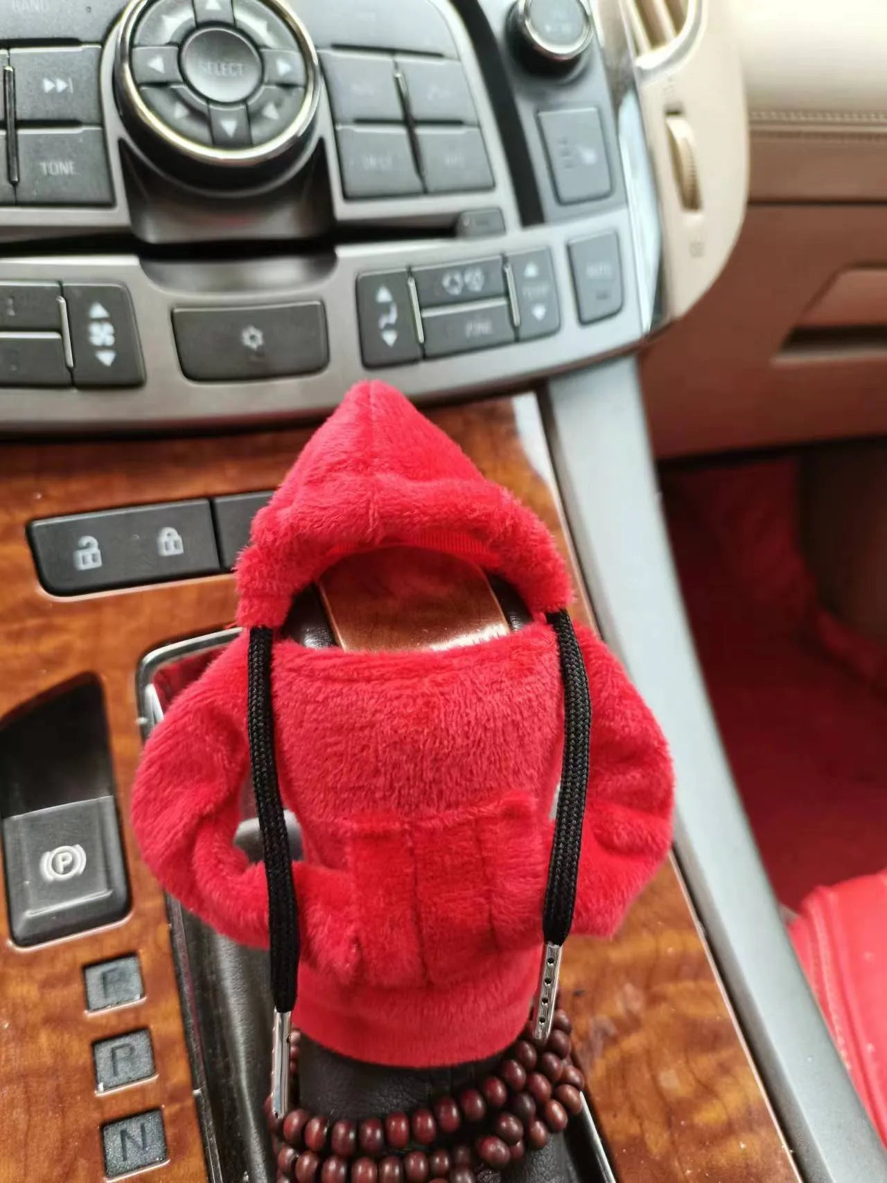 Dutch velvet car gear handle sleeve cover in multiple colours on a car gear lever.