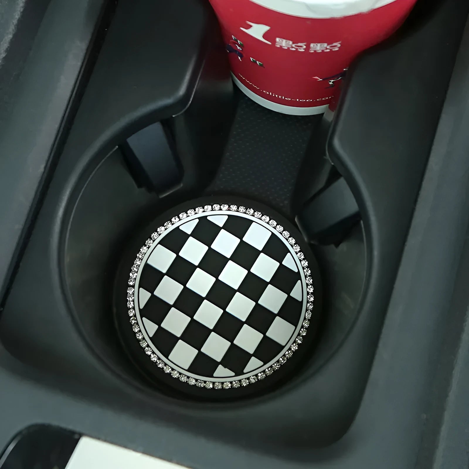 Black and white checkerboard PVC car cup mat inserted into a car door card slot.