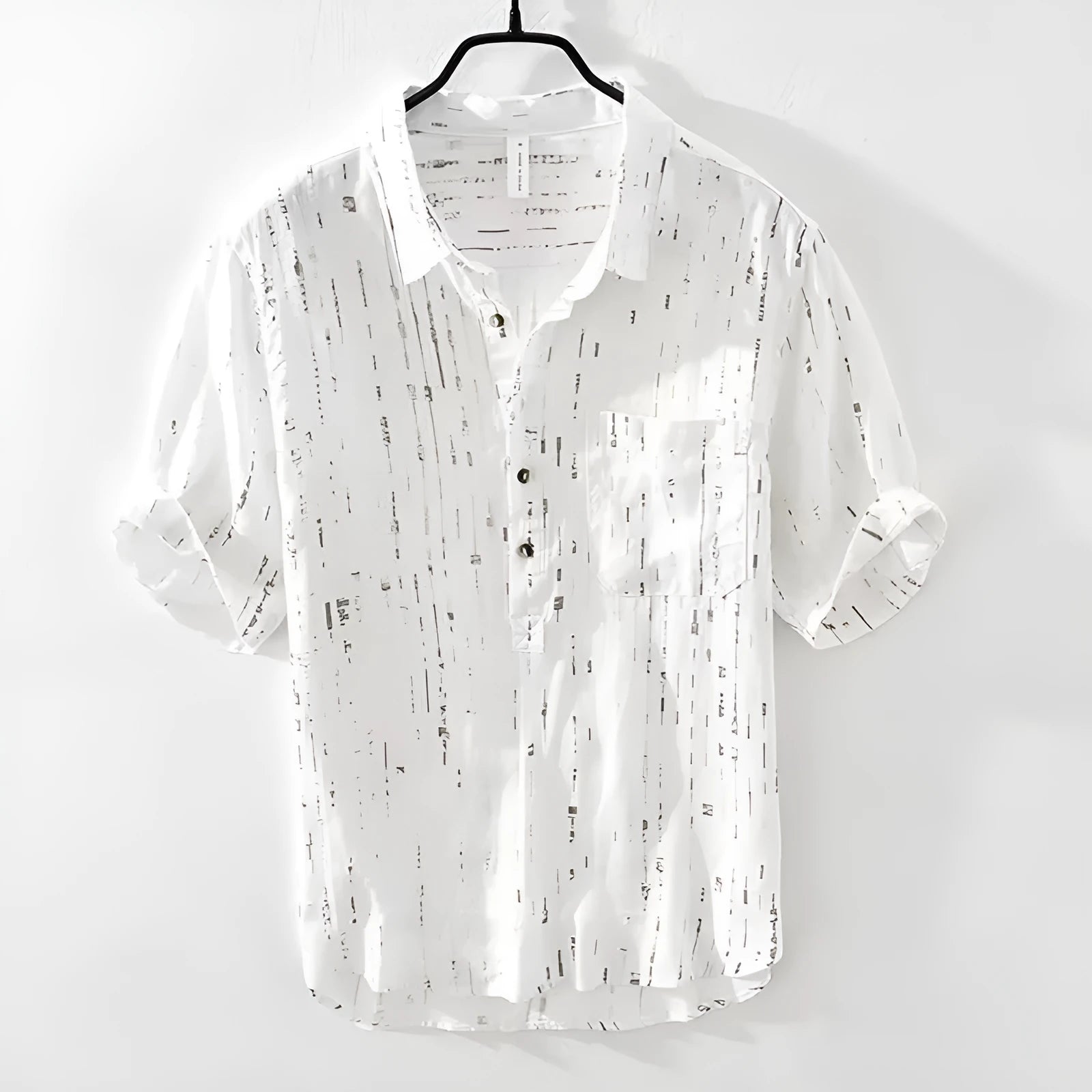 Man wearing a loose-fit black short-sleeved polo shirt, cardigan style, for casual summer wear.