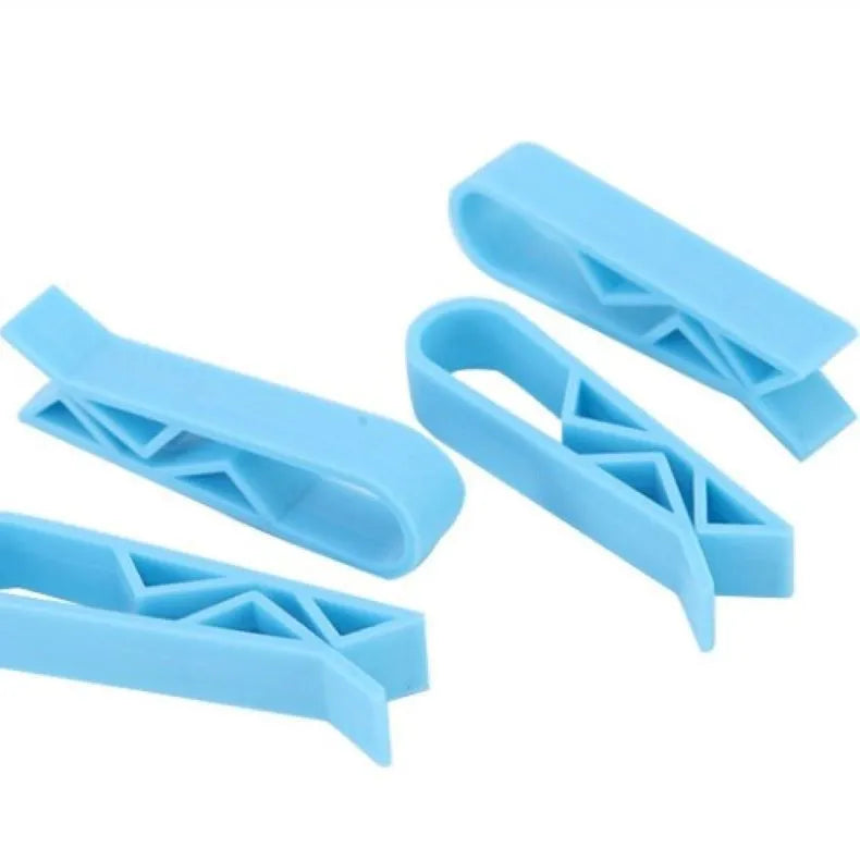 White PP plastic non-slip clip holding a black bin liner to the side of a silver kitchen trash can.