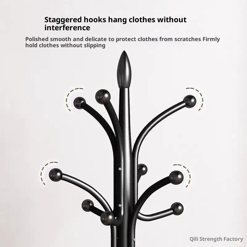 Floor-standing iron coat rack in black with vertical metal frame for hanging jackets and bags in a bedroom or hallway