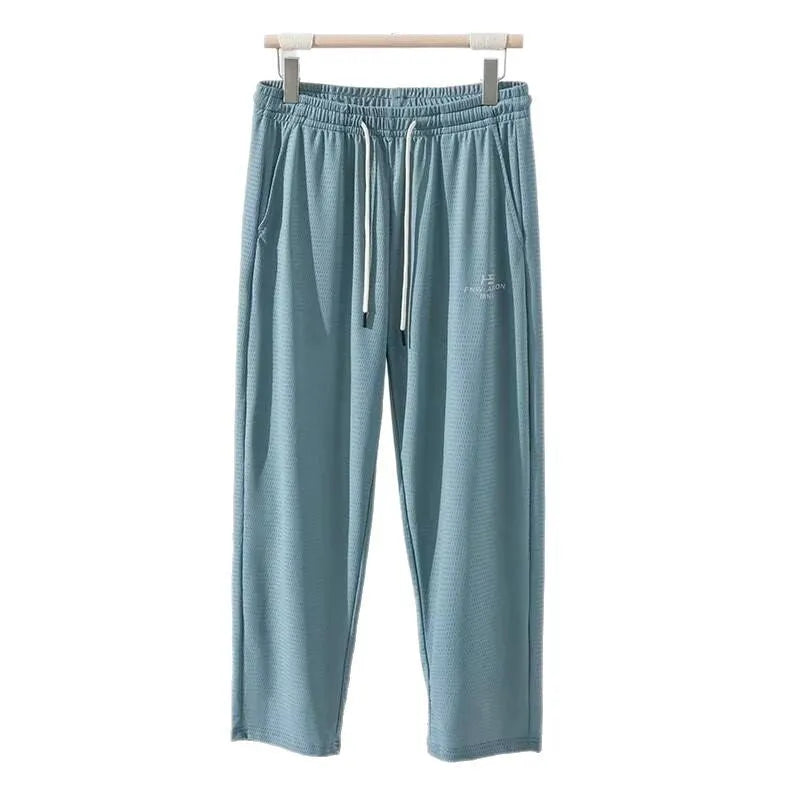 Men's ice silk thin breathable quick-drying casual pants in black, loose straight-leg style with drawstring waist