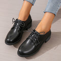 Black women's low-top slip-on work shoes with a chunky mid-heel and rounded toe.