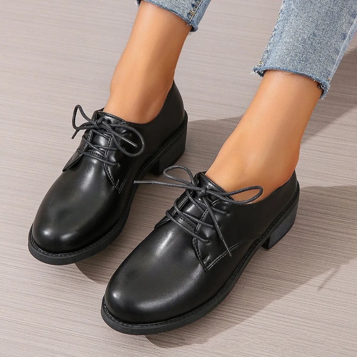 Black women's low-top slip-on work shoes with a chunky mid-heel and rounded toe.