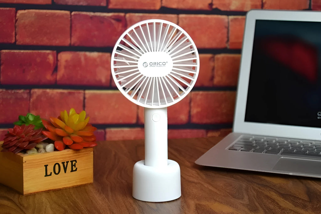 White ORICO FH1 portable USB desk fan with fine line design on a desktop.