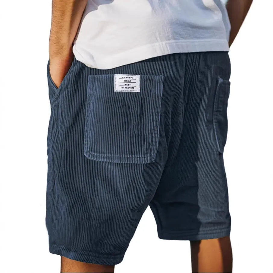 Men's grey corduroy shorts with multiple pockets and straight-leg cut on a neutral background.