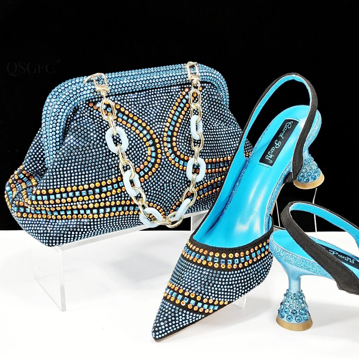 Women's pointed toe high heels with rhinestone details and matching small bag in synthetic leather