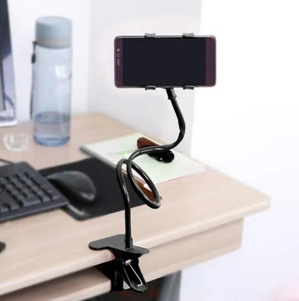 Black portable phone holder with a long flexible arm and a V-shaped clip, extended on a bedside table.