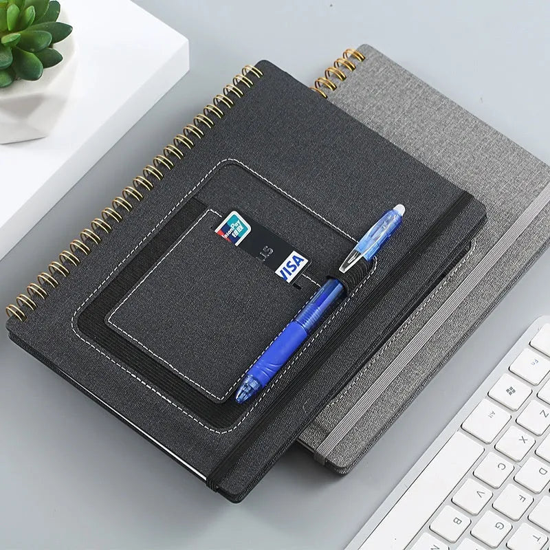 Reusable erasable coil notebook with stone paper, shown with a pen and available in multiple cover colour options.