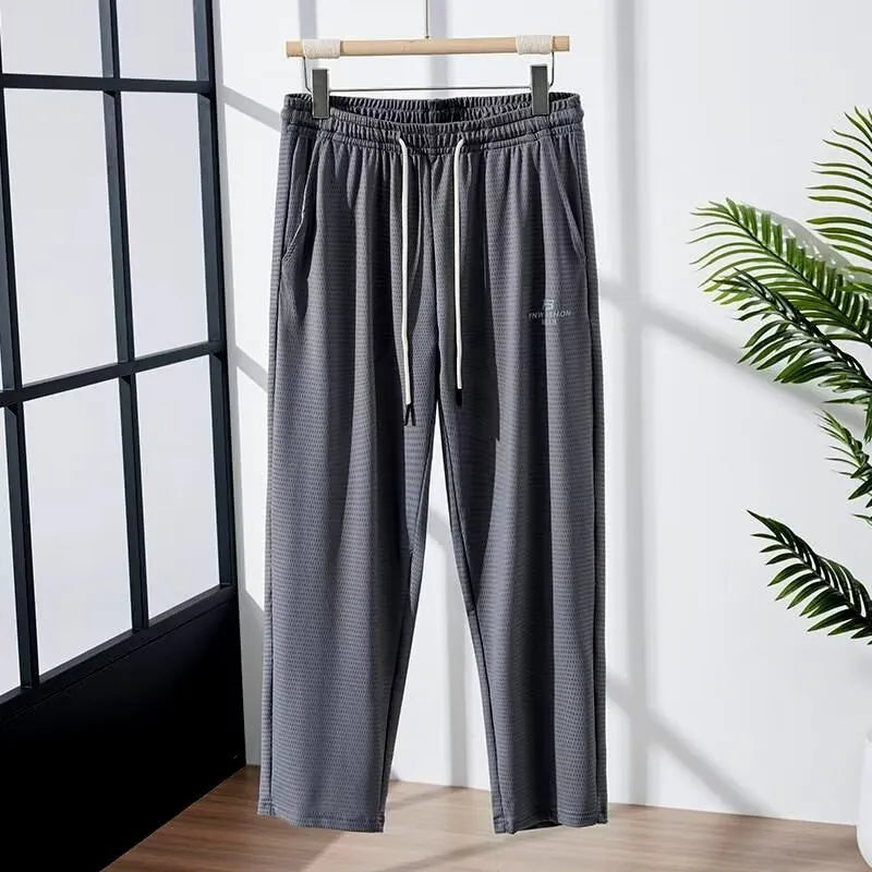 Men's ice silk thin breathable quick-drying casual pants in black, loose straight-leg style with drawstring waist