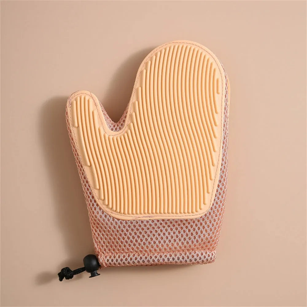 Right hand pet grooming glove in blue on fabric, showing mesh texture for removing cat and dog hair.