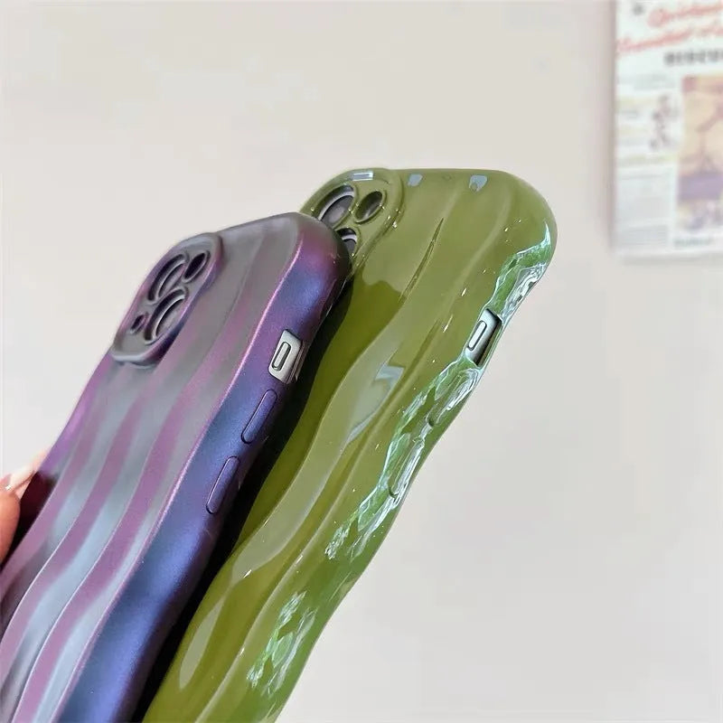 Silicone mobile phone case for iPhone 17 with a solid green colour and water ripple texture on a flat surface.