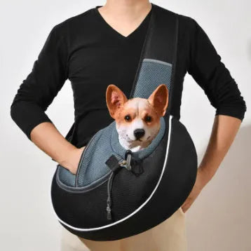 Women carrying black pet crossbody bag with small dog inside, Oxford material with drawstring closure