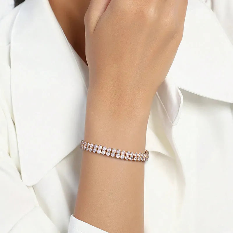 Unisex gold electroplated double-row diamond zirconia tennis chain bracelet on white background