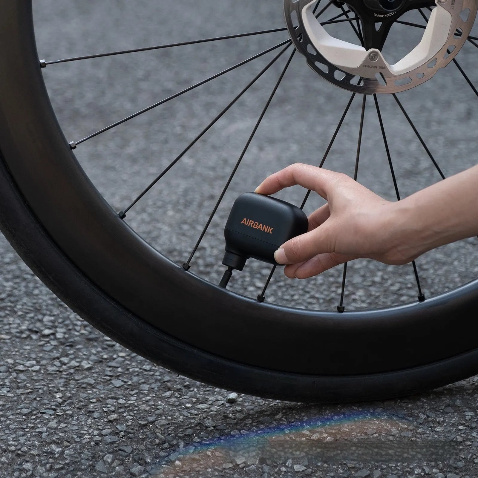 Black AS100 electric bicycle tyre inflator pump with USB charging cable and waterproof bag