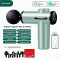 Konka professional electric mini massage gun in grey colour with multiple massage head attachments on a table.
