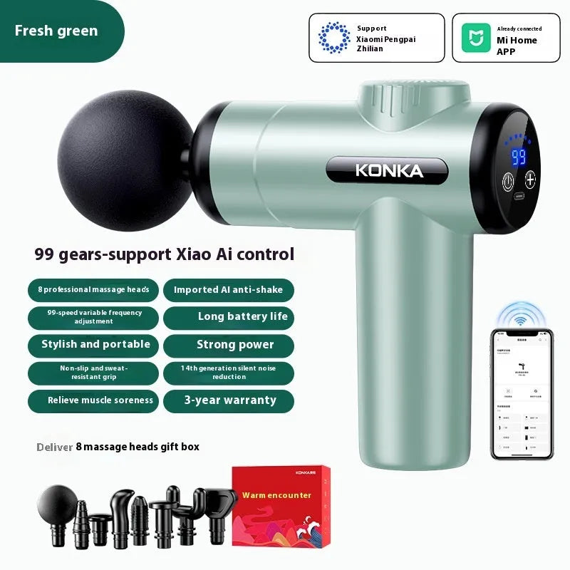 Konka professional electric mini massage gun in grey colour with multiple massage head attachments on a table.