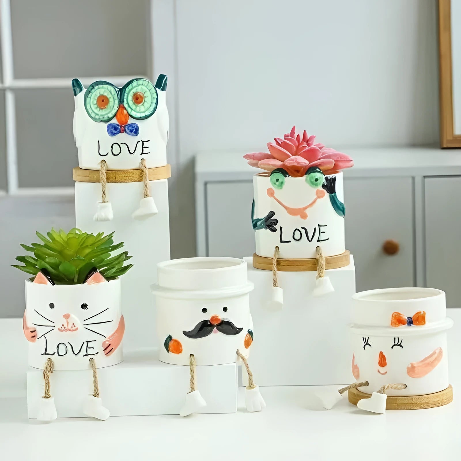 Cartoon style ceramic hanging foot flowerpot for succulent plants on a desktop.