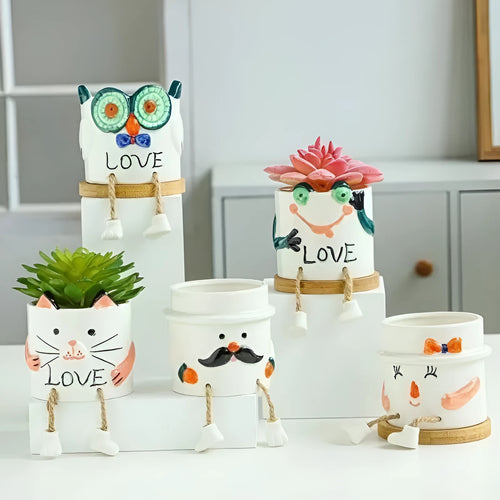 Cartoon style ceramic hanging foot flowerpot for succulent plants on a desktop.