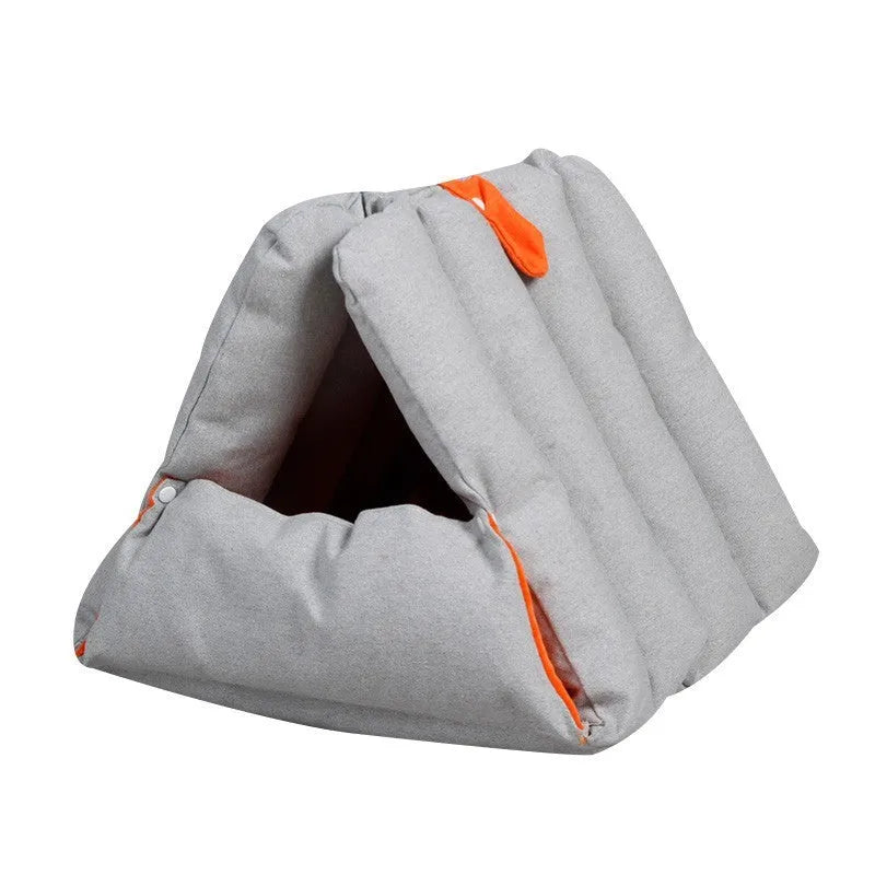 Triangular cat bed with blue removable cotton cover showing combination holes