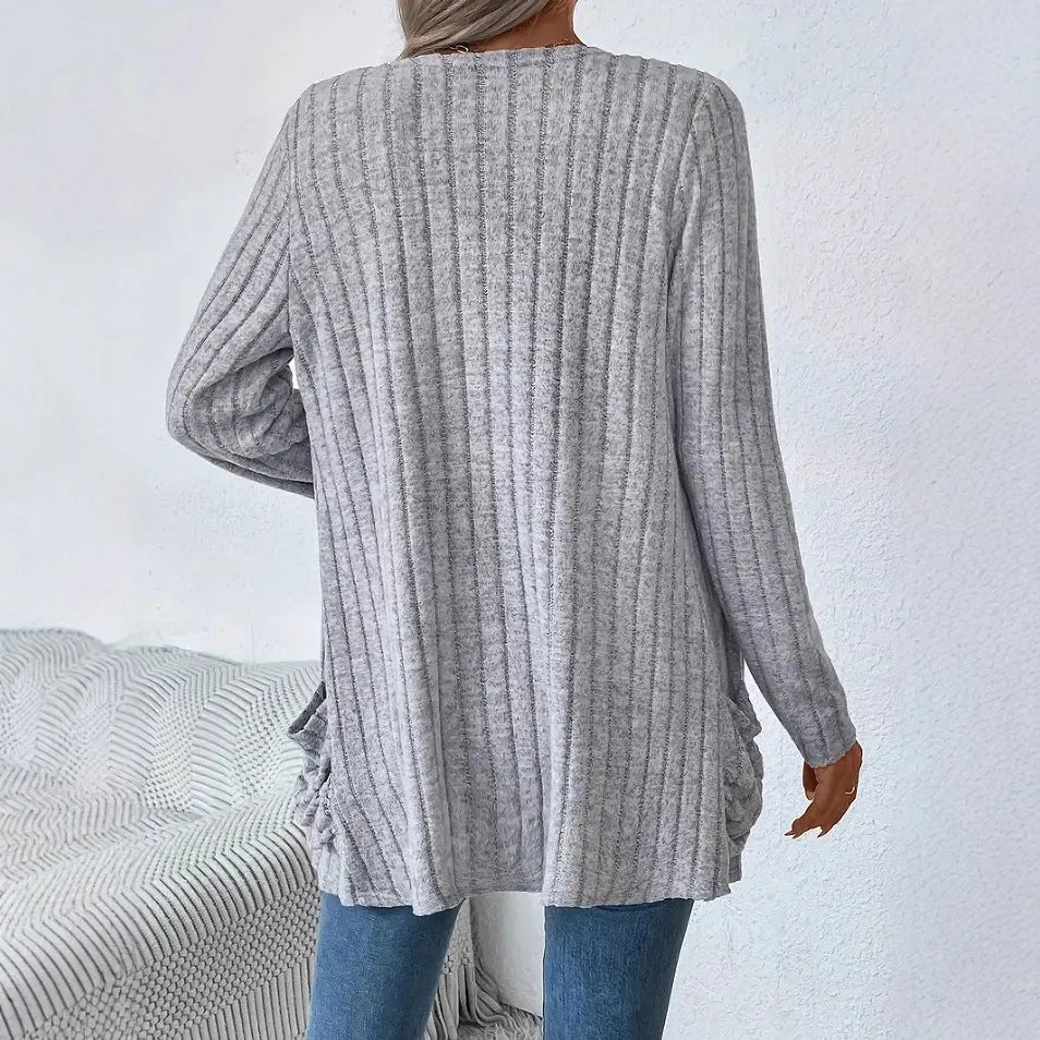 Solid colour loose fit long sleeve cardigan with front pocket in grey or black.