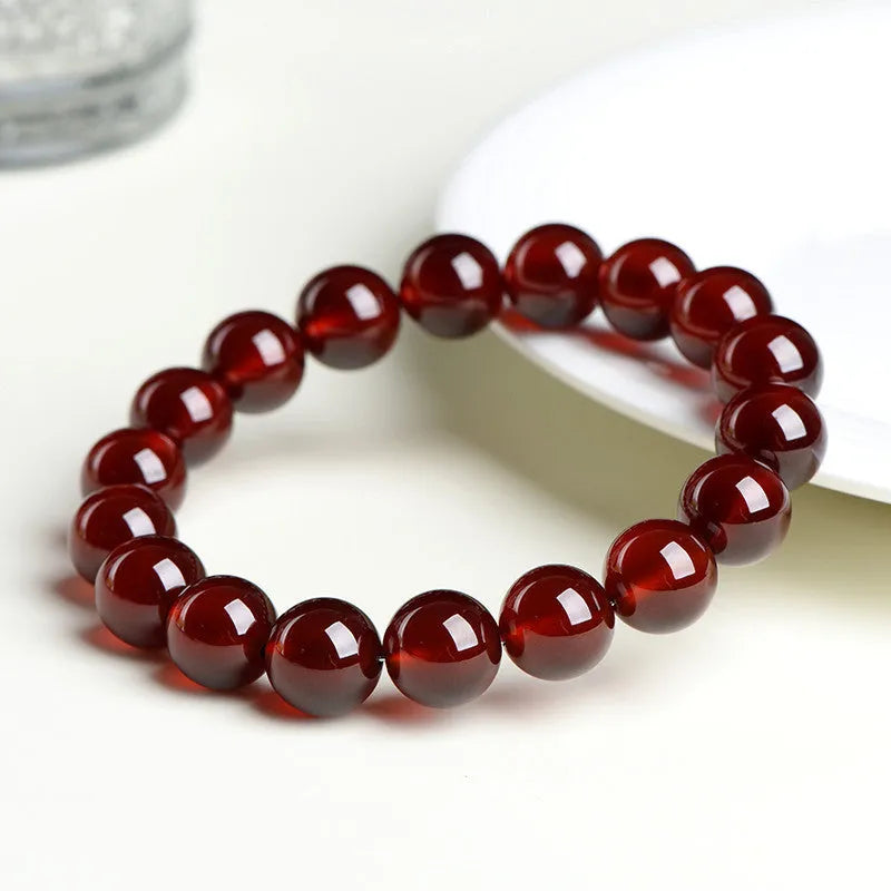 Natural orange red garnet ball crystal bracelet with Ruyi design in retro unisex style.