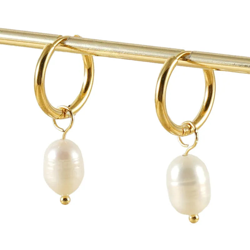 Gold geometric women's earrings made from stainless steel with a central pearl and titanium posts.